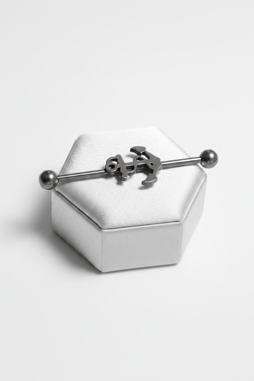 Anchor Industrial Ear Barbell in 316l stainless steel on a silver jewelry display side angle.