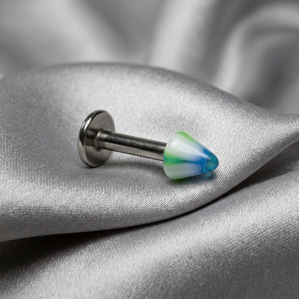 Green Striped Acrylic Spike Labret Lip Ring in 316l stainless steel on silver silk fabric.