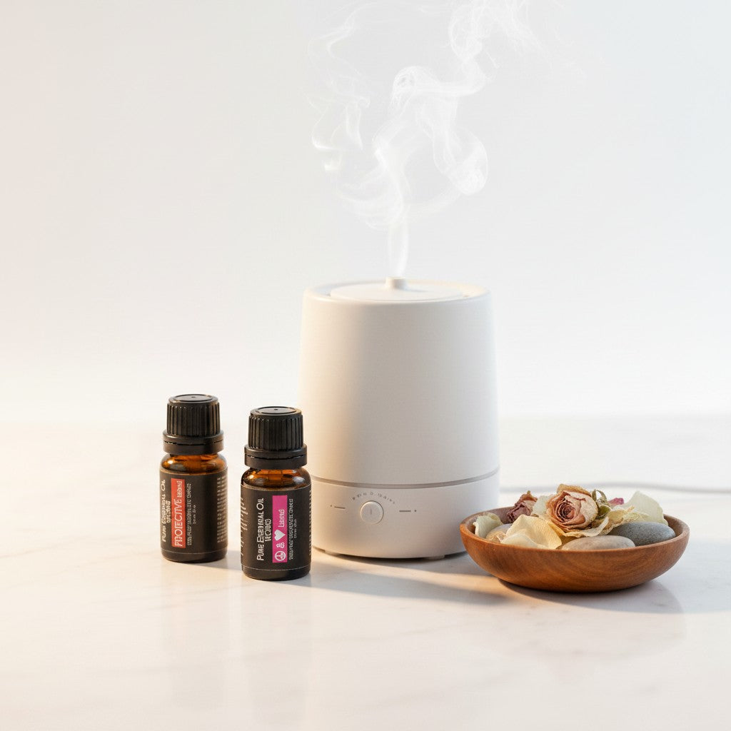 Love & Protection Essential Oil Blends 2 Pack Special in an aromatherapy setting with a diffuser burning and smoke rising.