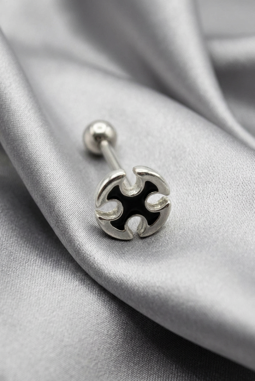 Maltese Cross Tongue Piercing in 316l stainless steel on silver silk fabric.