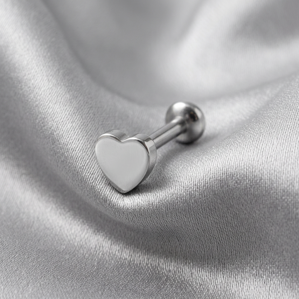 Internally Threaded Heart Labret Lip Ring in 316l stainless steel on silver silk fabric.