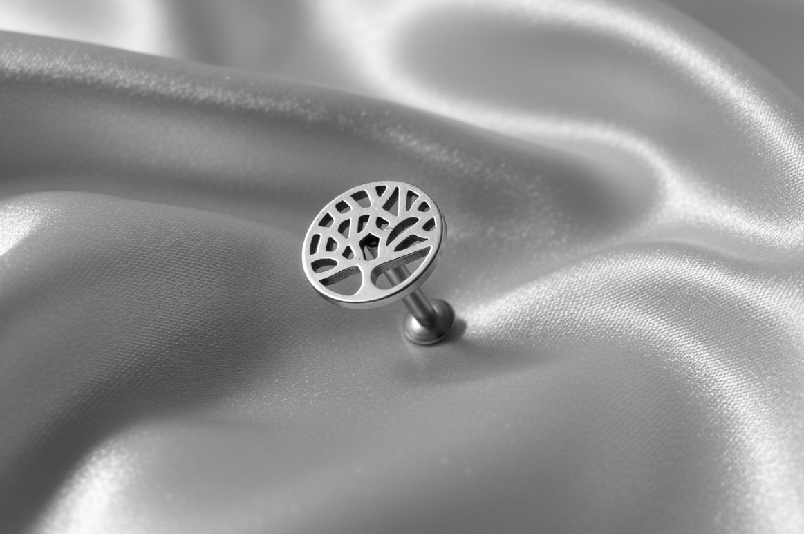 Internally Threaded Elegant Tree of Life Labret Lip Ring in 316l stainless steel angled left.