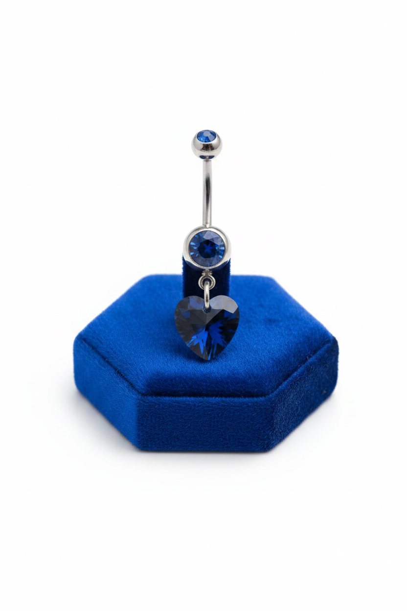 Blue Crystal Heart Belly Button Ring in 316l stainless steel on a blue velvet jewelry display.