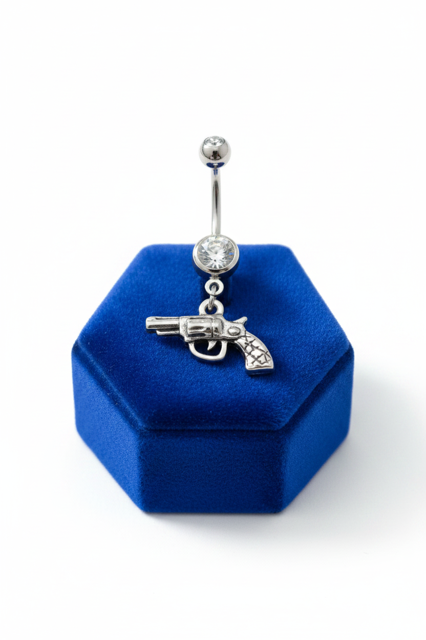 Clear Crystal Handgun Belly Button Ring in 316l stainless steel on a blue velvet jewelry display.