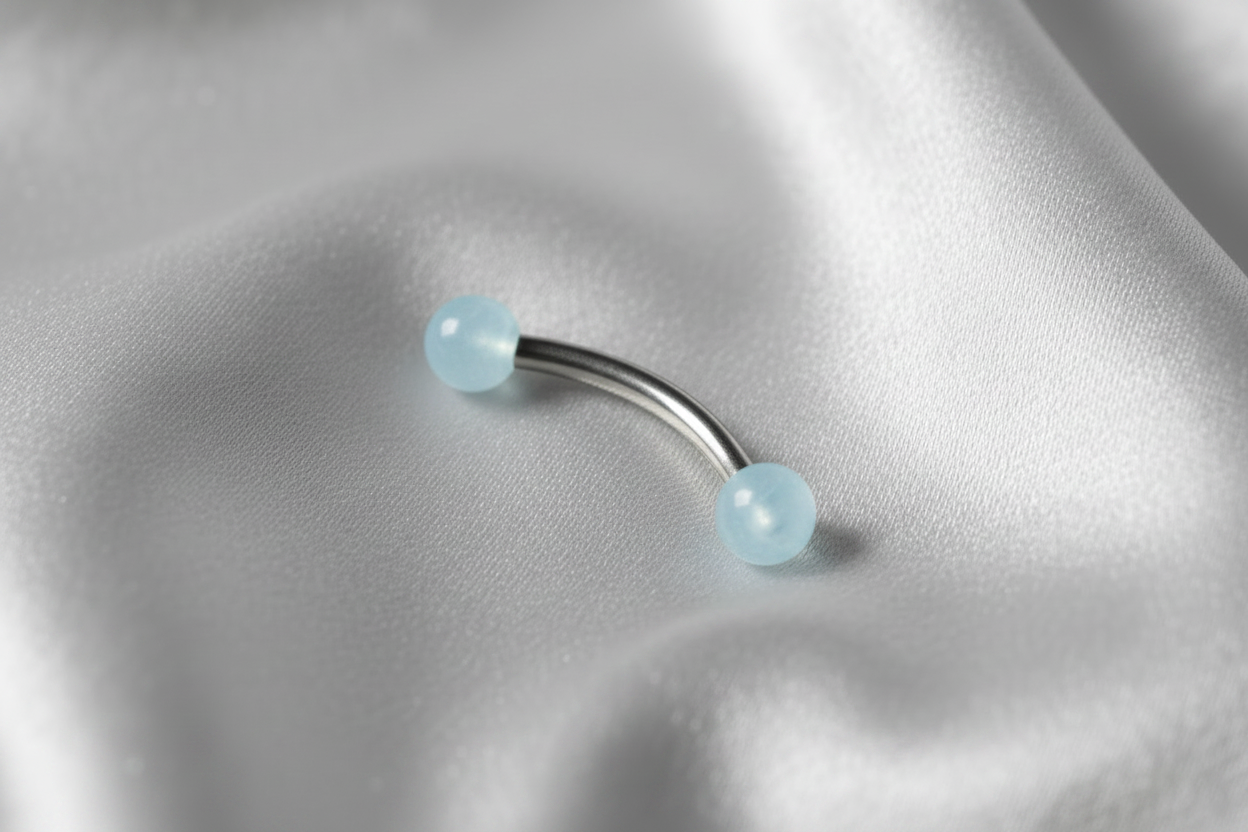 Blue Glow Ball Acrylic Eyebrow Ring in 316l stainless steel.