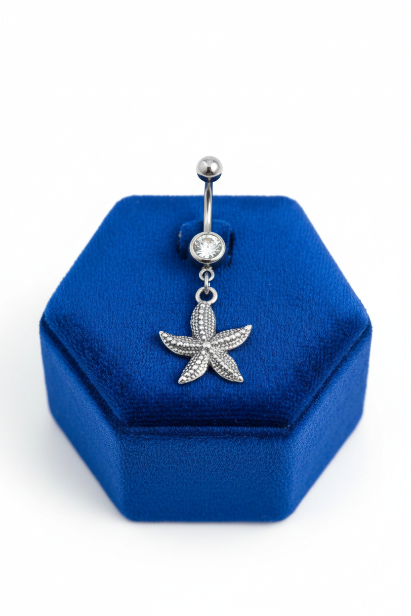 Clear Crystal Star Fish Belly Button Ring in 316l stainless steel on a blue velvet jewelry display.