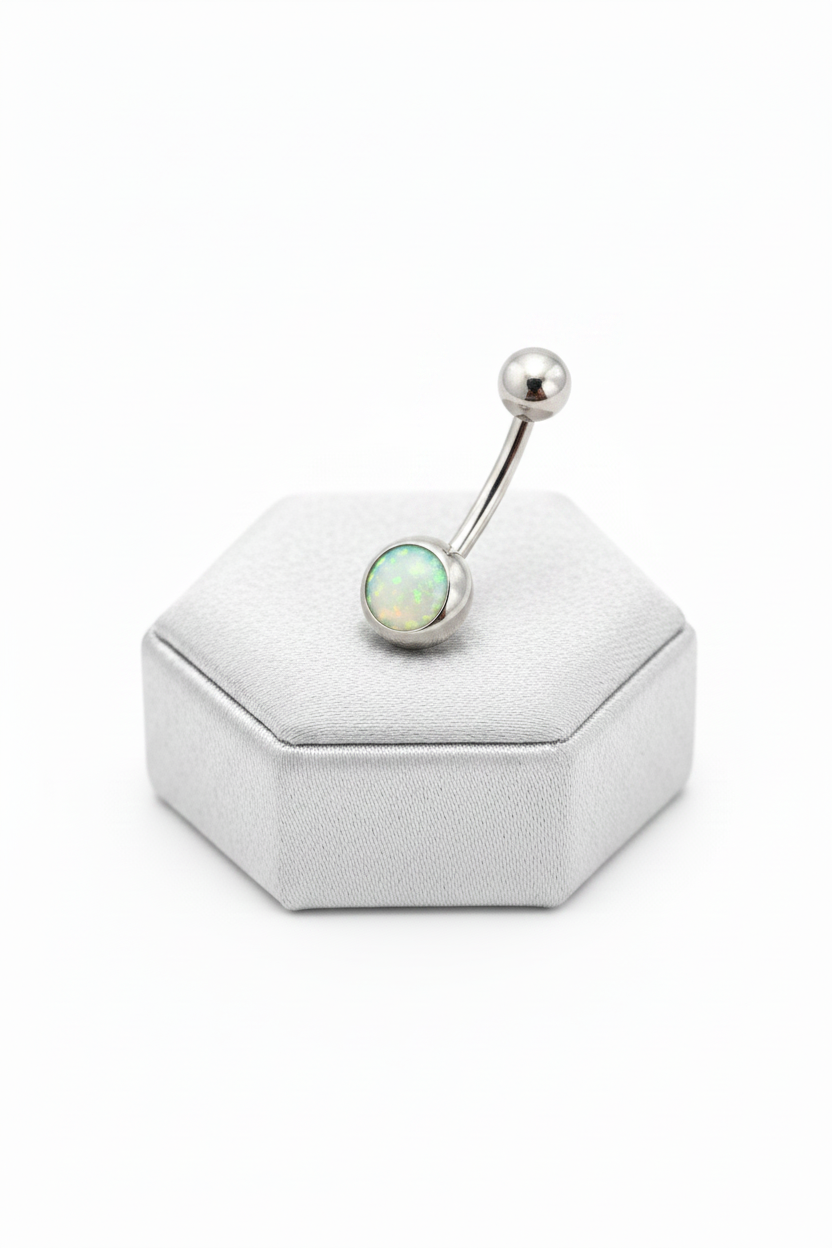 Aqua Opal Belly Button Ring in 316l stainless steel on a silver jewelry display.