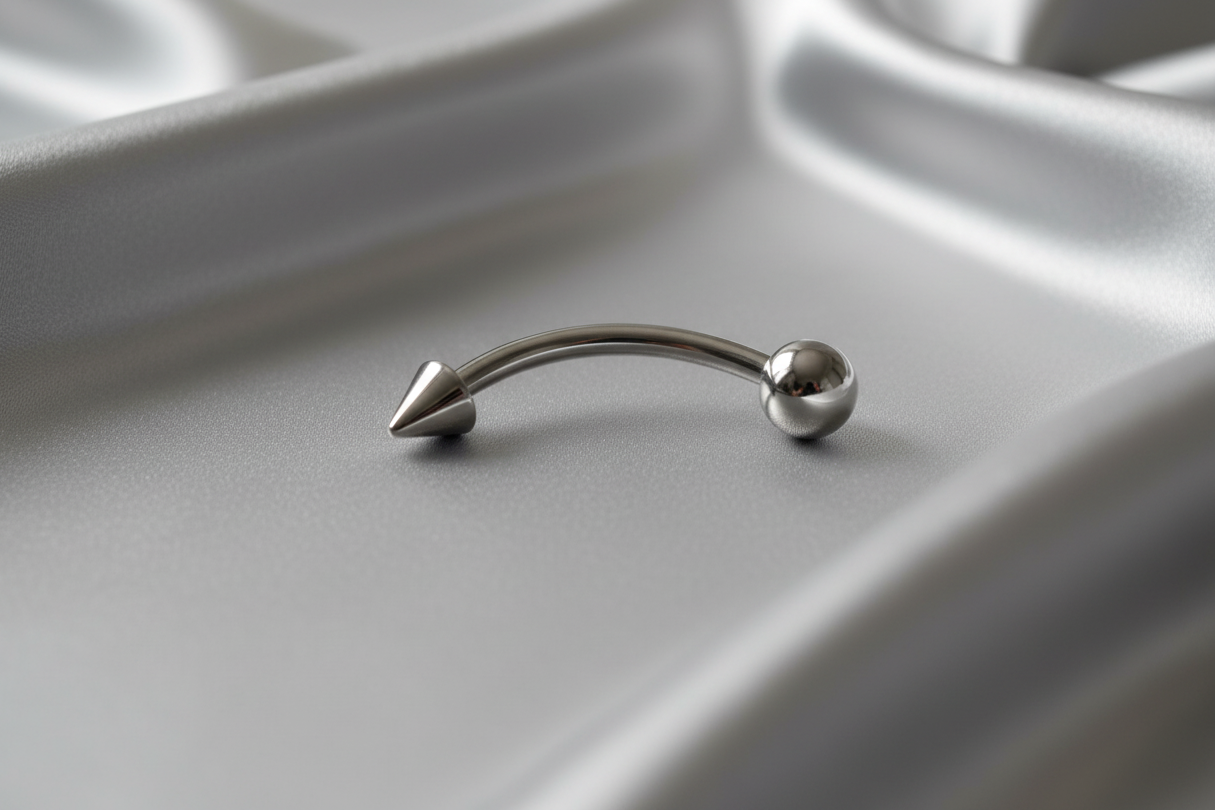 Steel Ball and Spike Eyebrow Ring in 316l stainless steel.