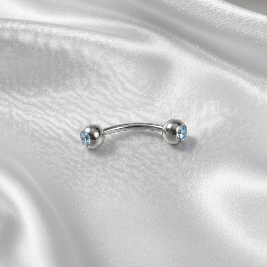 Sky Blue Crystal Ball Eyebrow Ring in 316l stainless steel.
