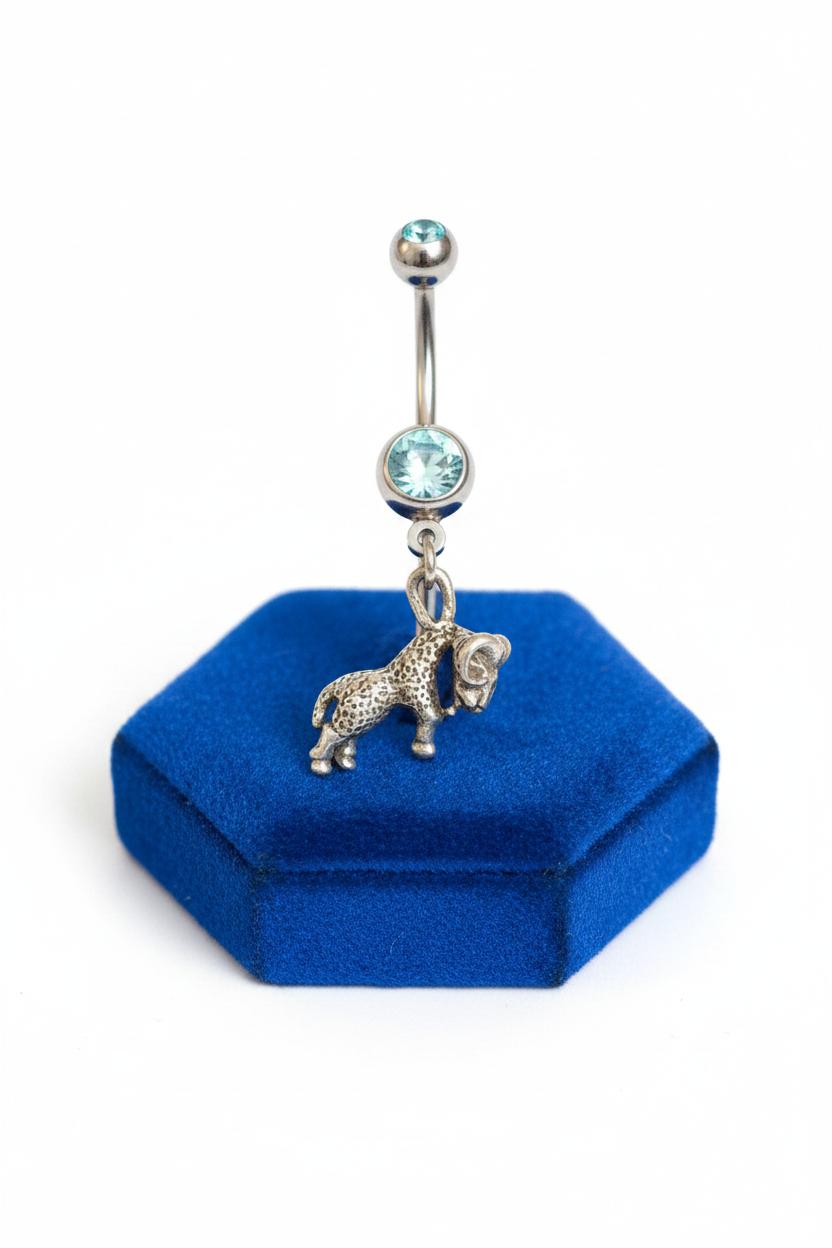 Aqua Crystal Aries Ram Belly Button Ring in 316l stainless steel on a blue velvet jewelry display.