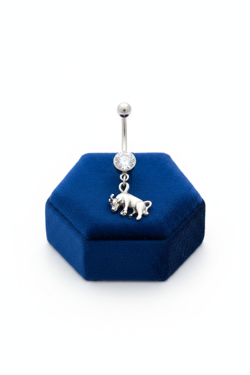 Clear Crystal Taurus Belly Button Ring in 316l stainless steel on a blue velvet jewelry display.