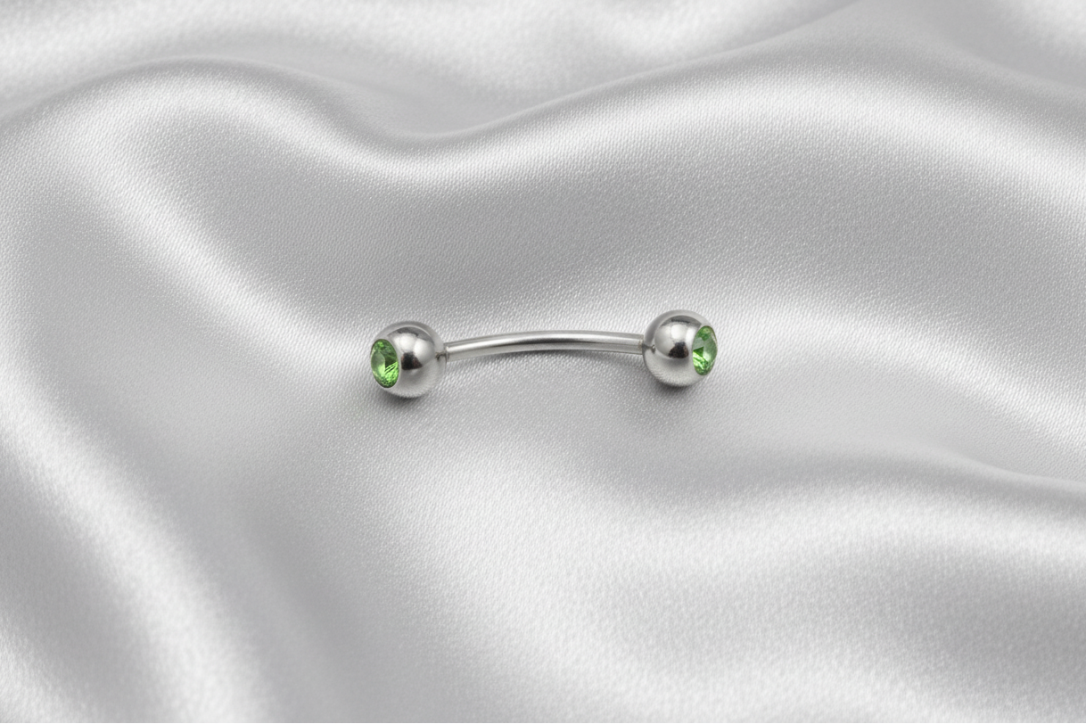 Green Crystal Ball Eyebrow Ring in 316l stainless steel.