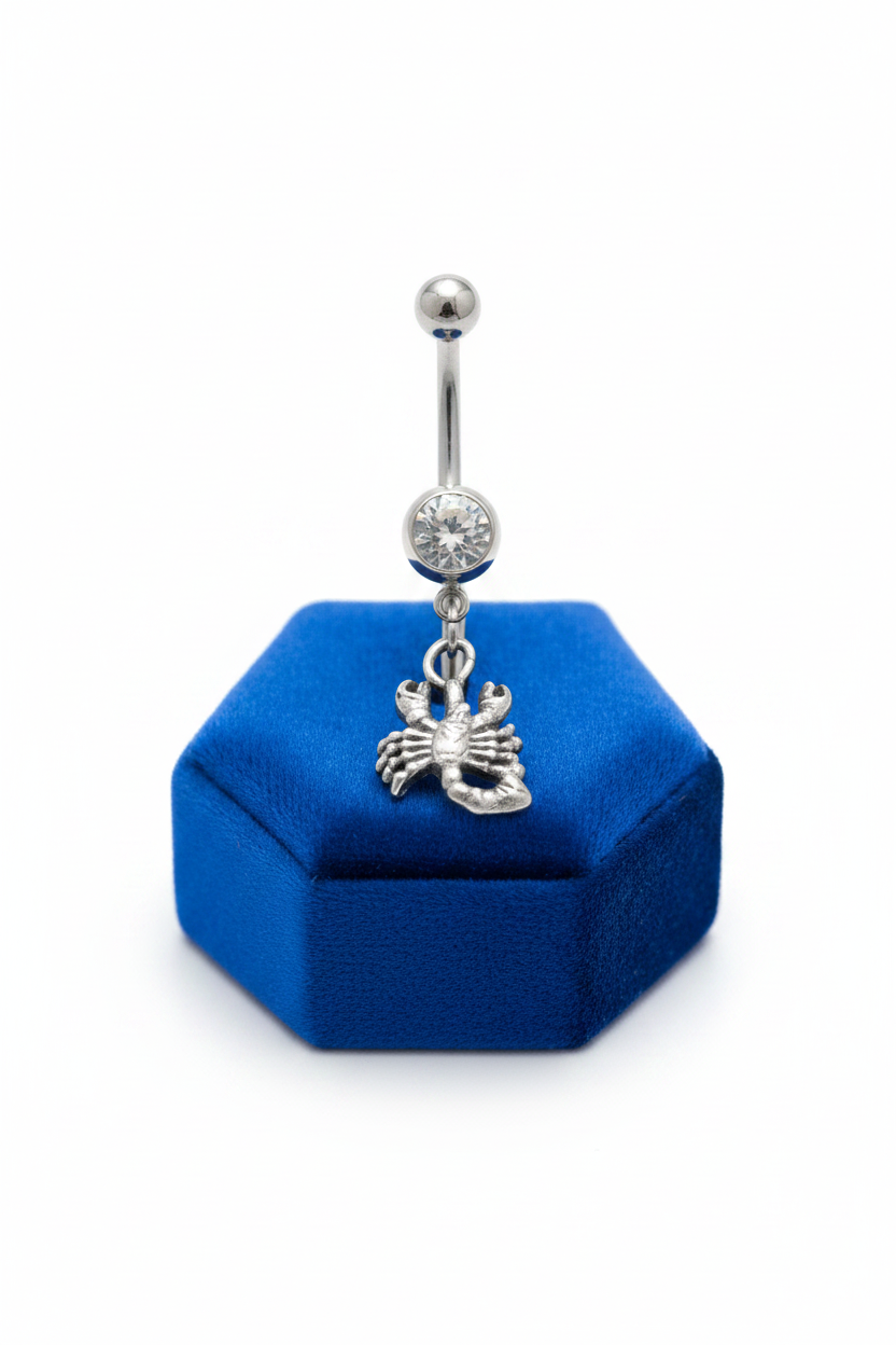 Clear Crystal Scorpio Belly Button Ring in 316l stainless steel on a blue velvet jewelry display.
