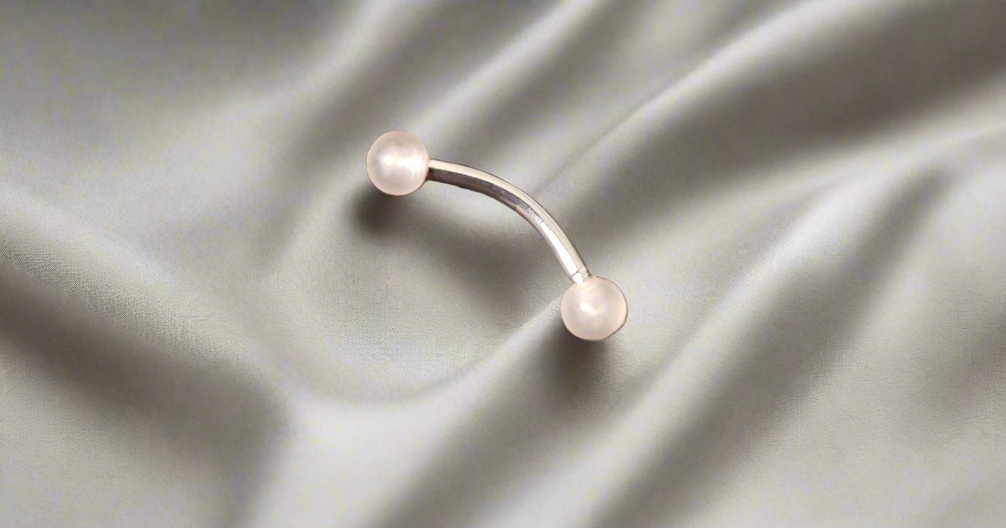 Steel Eye Brow Piercing with Peach Glow Acrylic Ball Ends