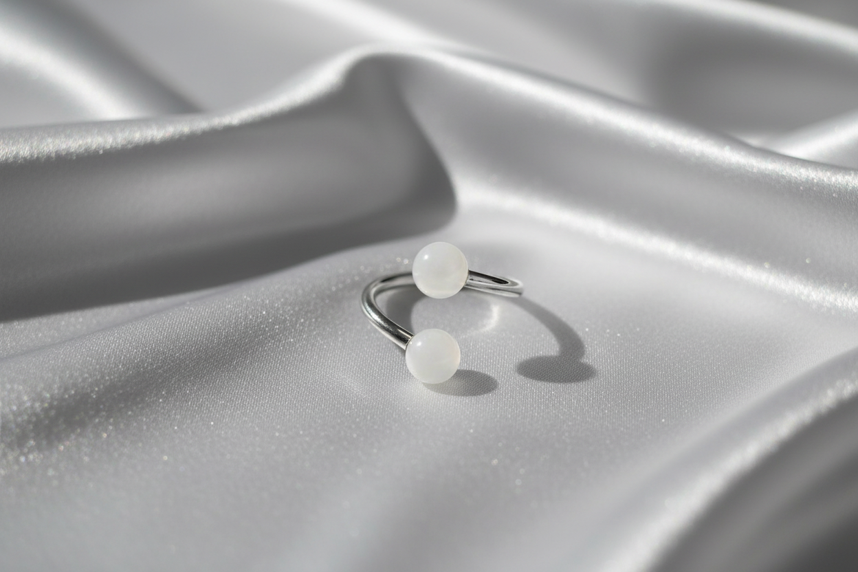 White Acrylic Glow Curled Barbell in 316l stainless steel.