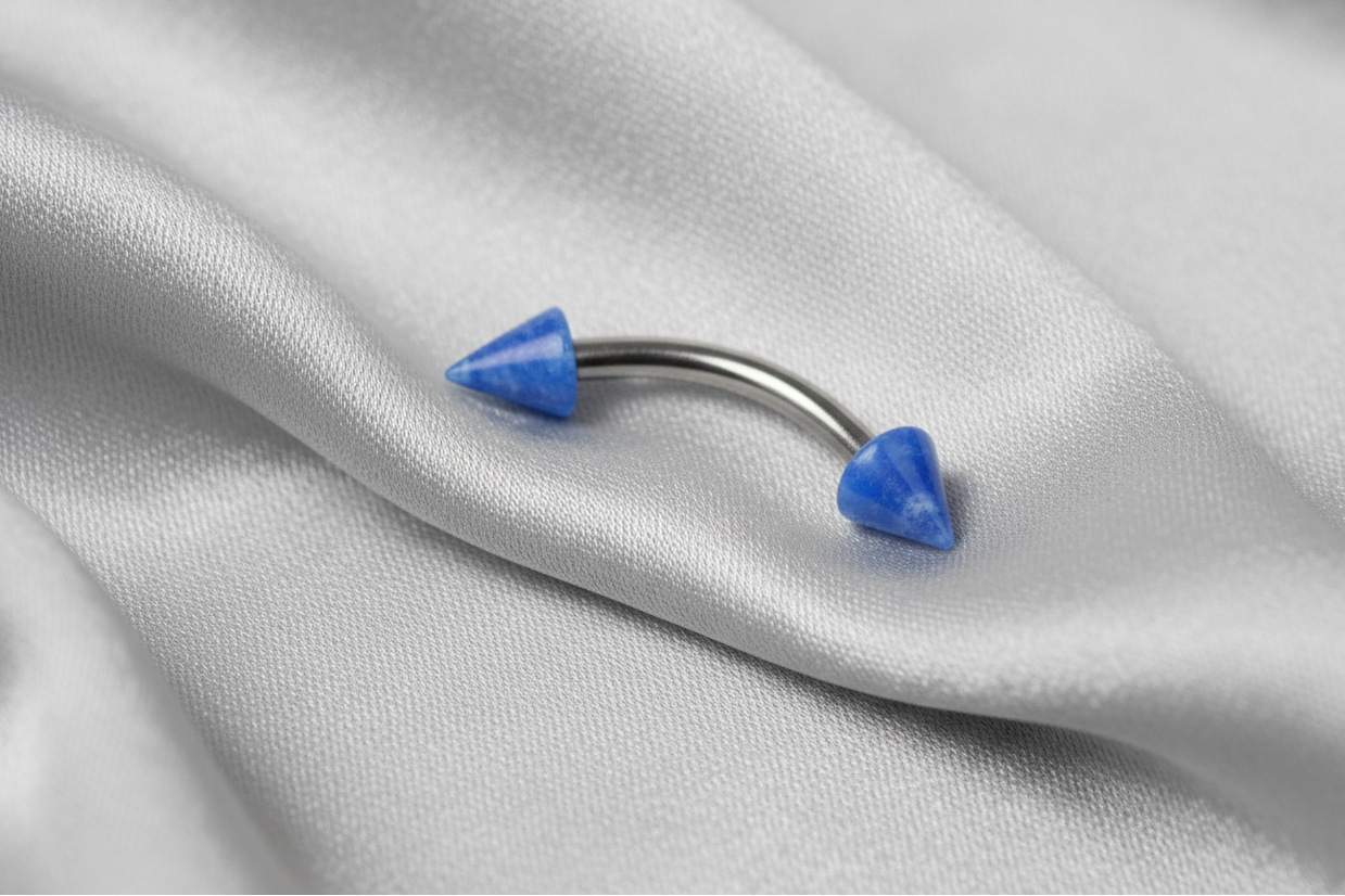 Blue Glow Acrylic Spike Eyebrow Ring in 316l stainless steel.