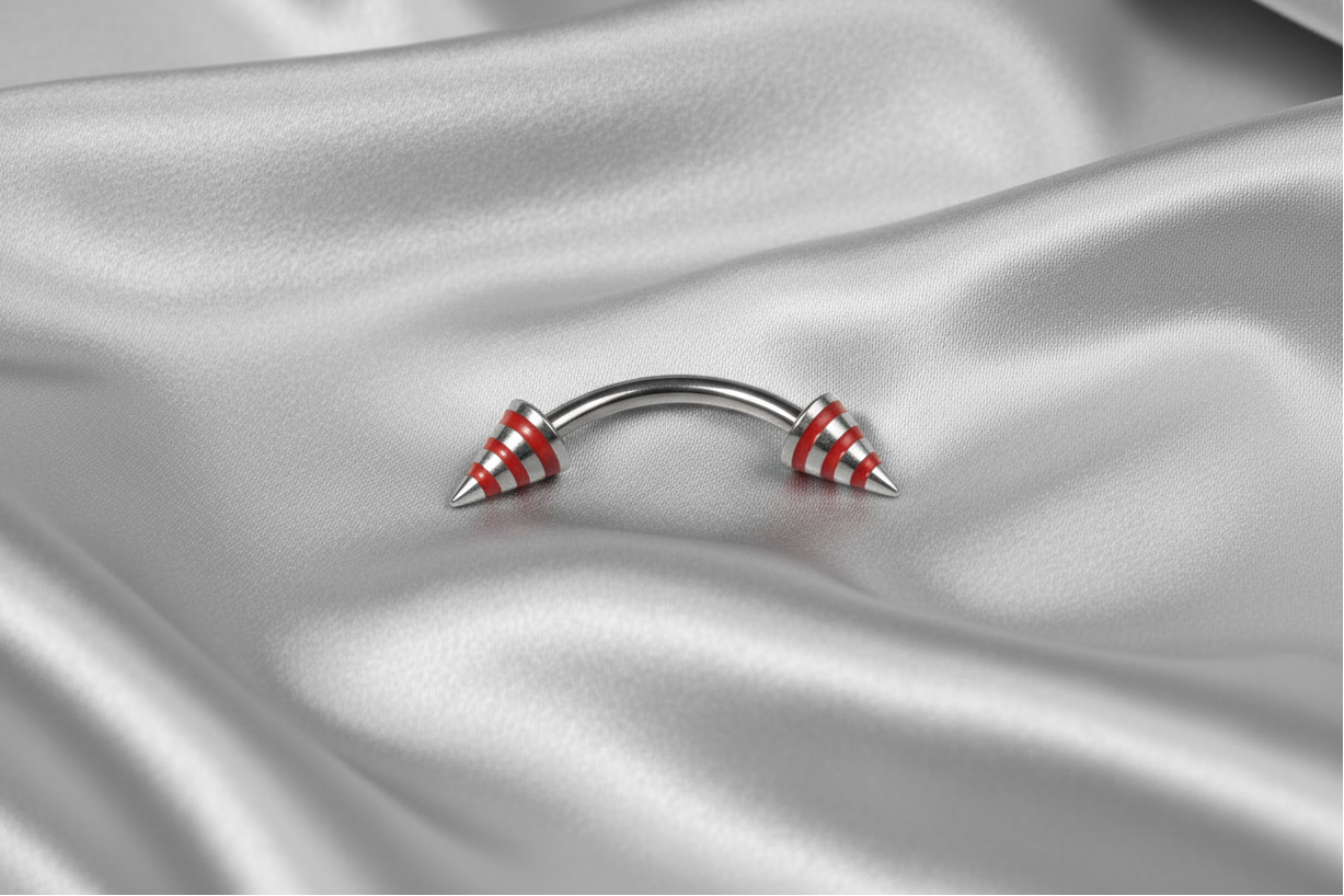 Red Striped Steel Spike Eyebrow Ring in 316l stainless steel.