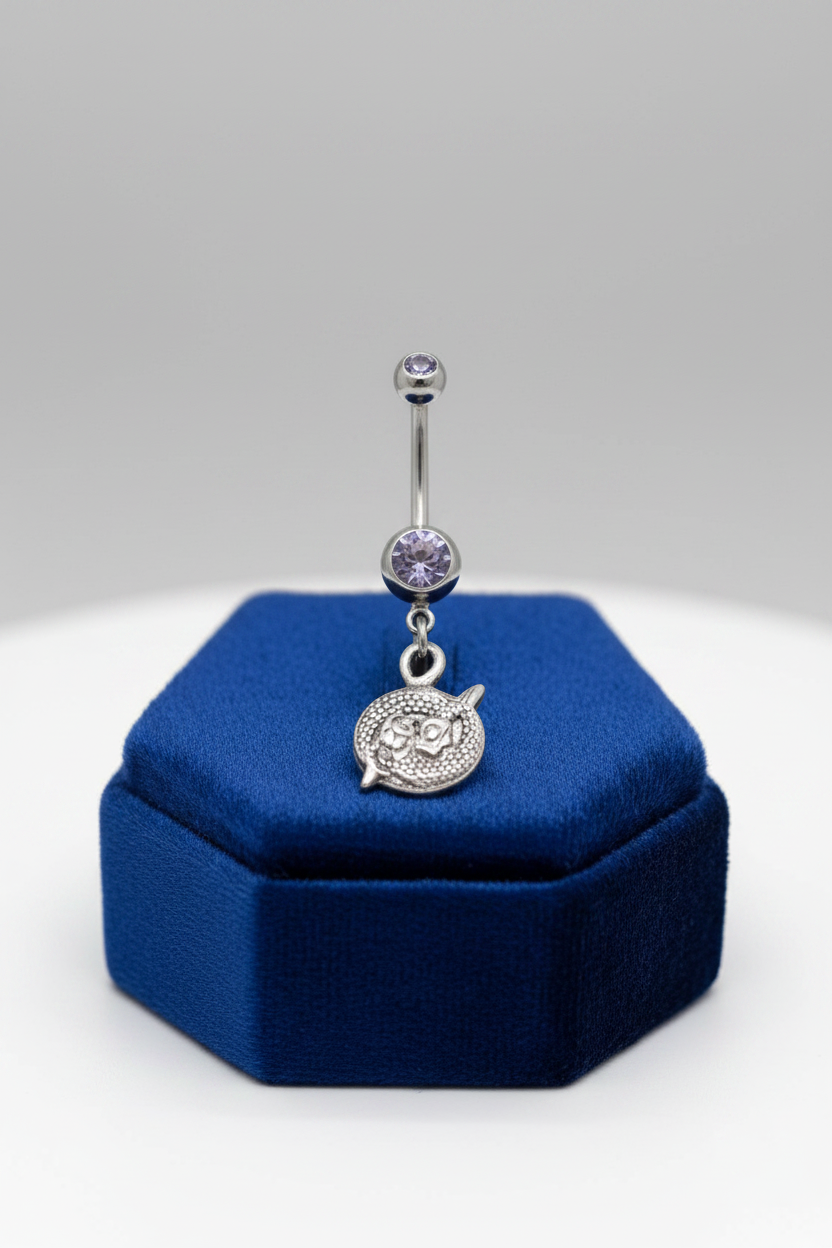 Purple Crystal Pisces Belly Button Ring in 316l stainless steel on a blue velvet jewelry display.