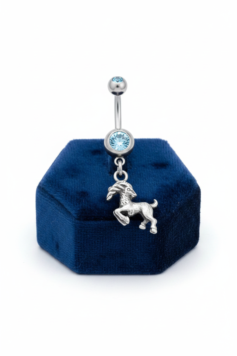 Blue Crystal Capricorn Belly Button Ring in 316l stainless steel on a blue velvet jewelry display.