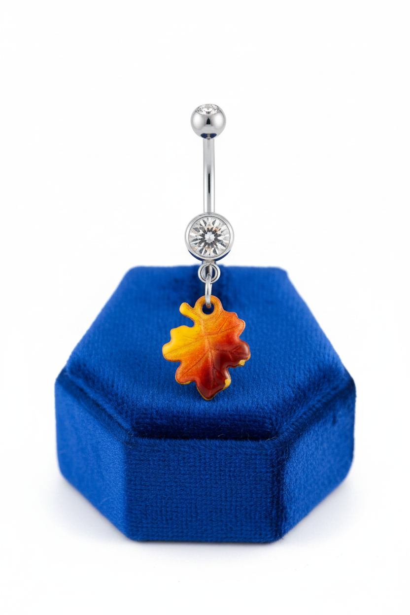 Clear Crystal Maple Leaf Belly Button Ring in 316l stainless steel on a blue velvet jewelry display.