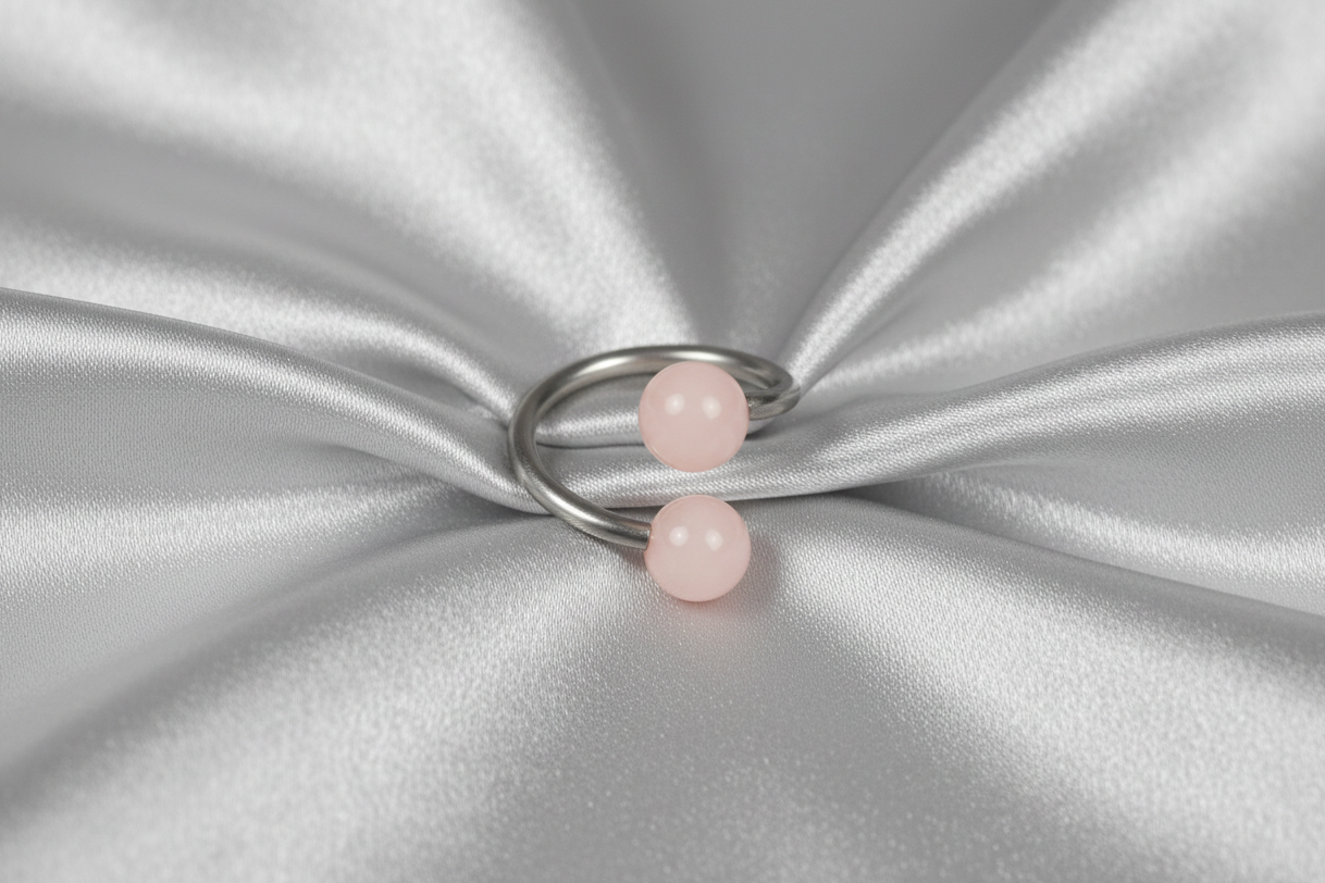 Powder Pink Acrylic Glow Curled Barbell in 316l stainless steel.