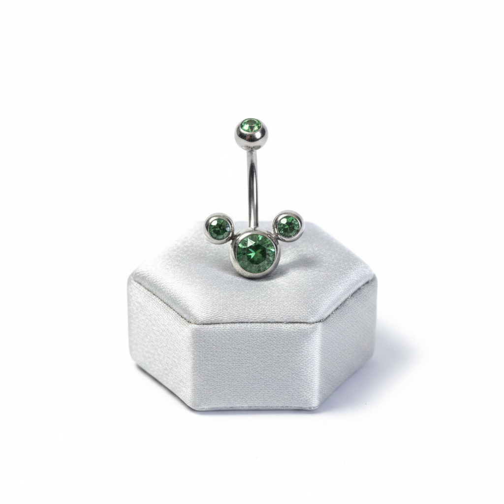 Green Crystal Belly Button Ring in 316l stainless steel on a silver jewelry display upright position.