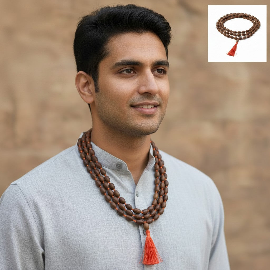 Sacred Lotus Seed Mala with Red Tassel around the neck of an East Indian male model worn as a necklace.