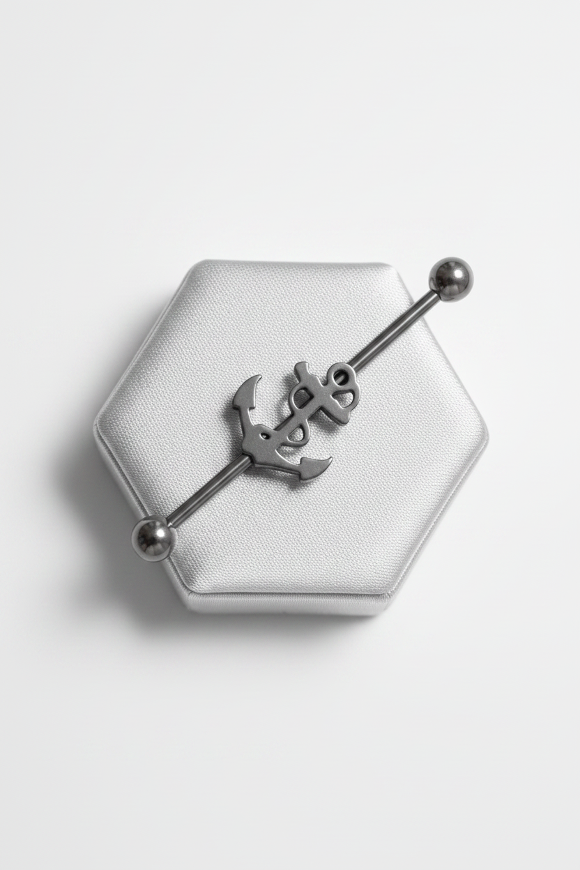Anchor Industrial Ear Barbell in 316l stainless steel on a silver jewelry display.