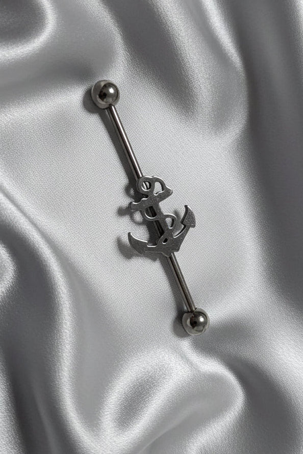 Anchor Industrial Ear Barbell in 316L stainless steel on silver silk fabric.