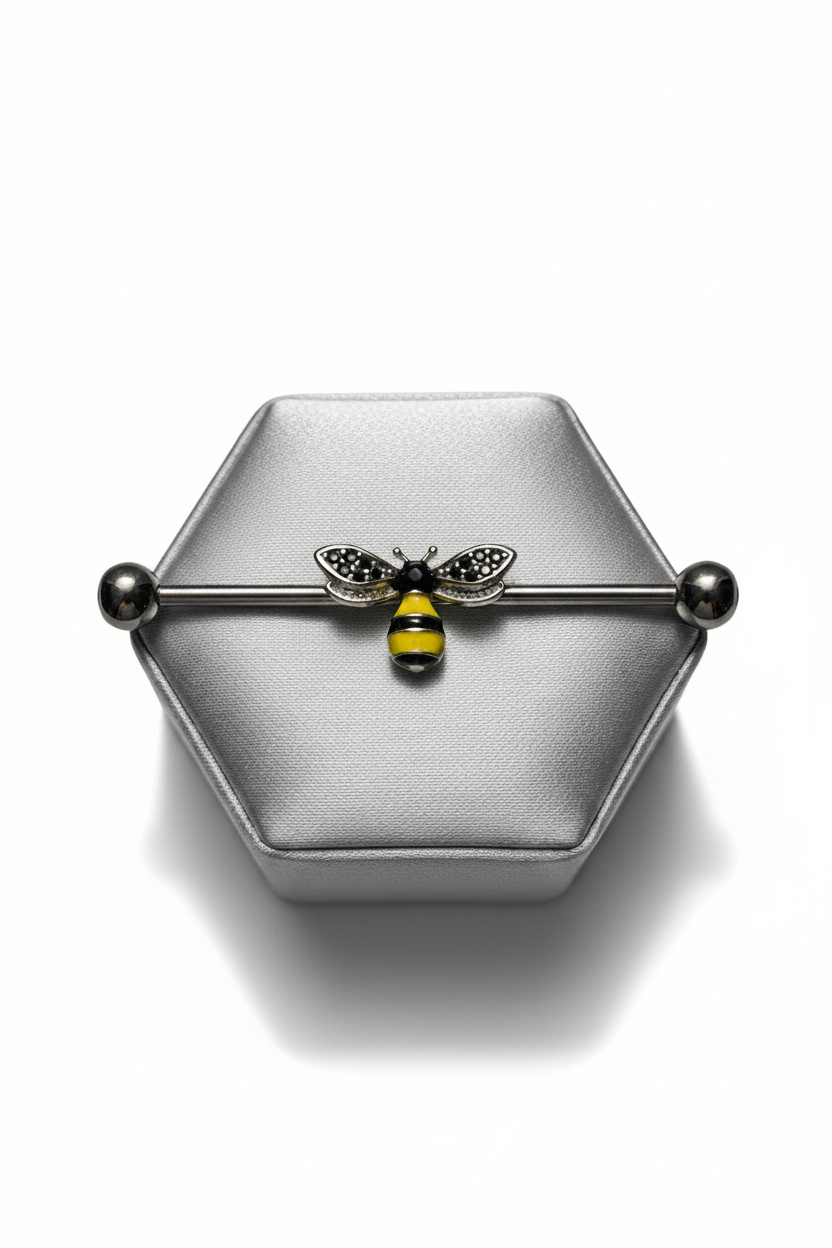 Honey Bee Industrial Ear Barbell in 316l stainless steel on a silver silk jewelry display.