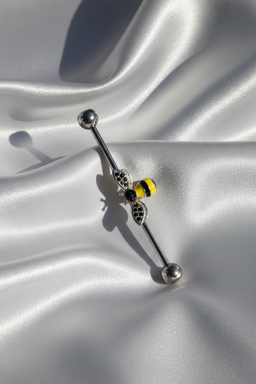 Honey Bee Industrial Ear Barbell in 316l stainless steel on silver silk fabric.
