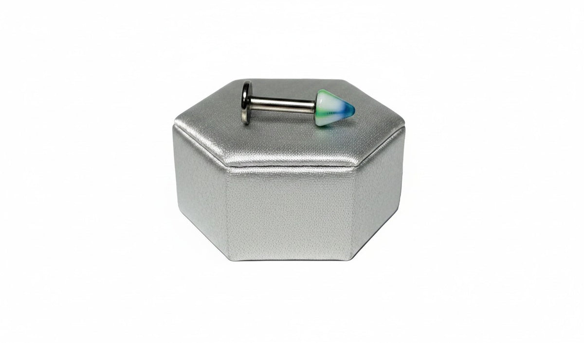 Green Striped Acrylic Spike Labret Lip Ring in 316l stainless steel on a silver silk jewelry display.