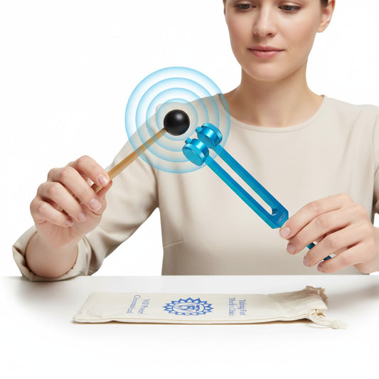 Blue Throat Chakra Aluminum Tuning Fork with Silencers 141.27 Hz being held by a female model and actively struck showing sound waves.