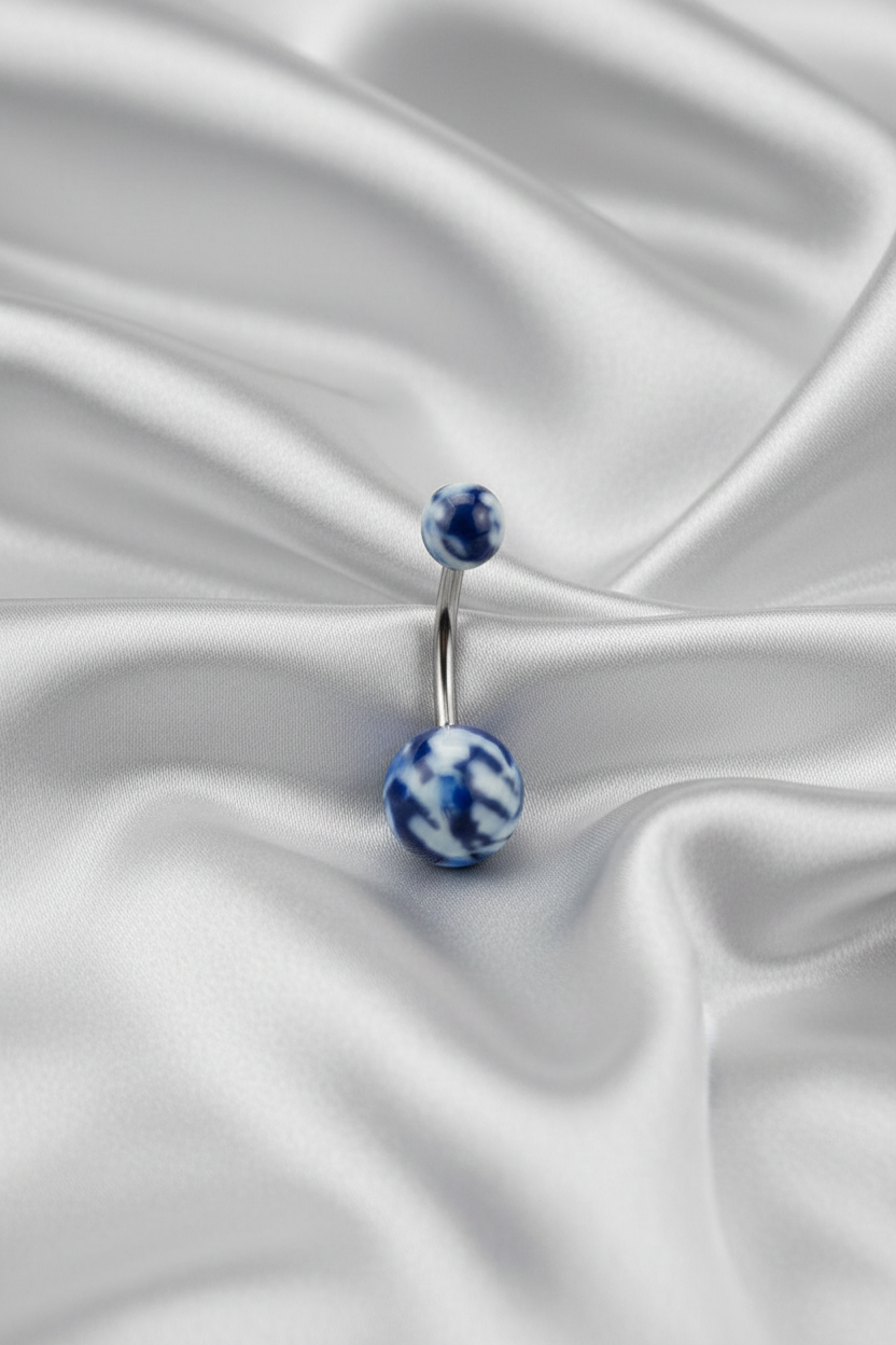 Blue Camouflage Acrylic Belly Button Ring in 316l stainless steel on silver silk fabric.
