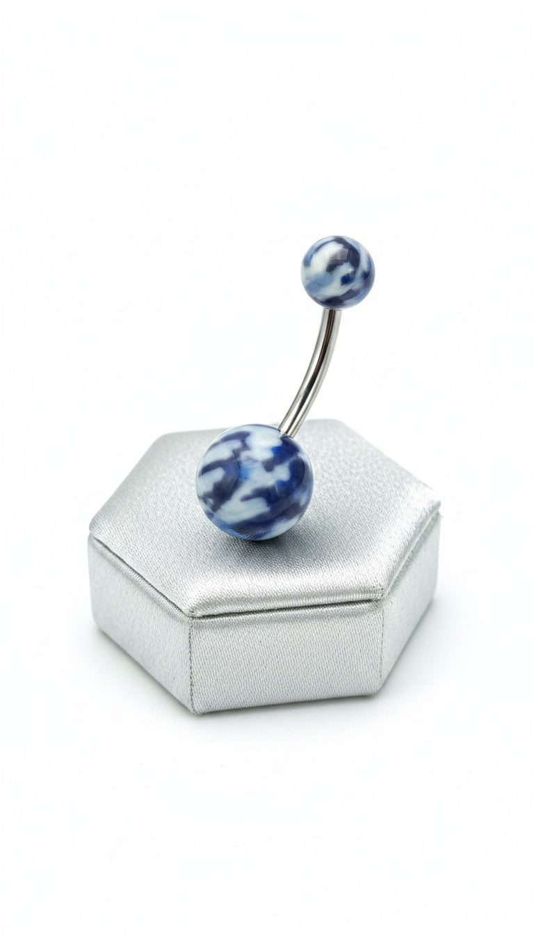 Blue Camouflage Acrylic Belly Button Ring in 316l stainless steel on a silver jewelry display.