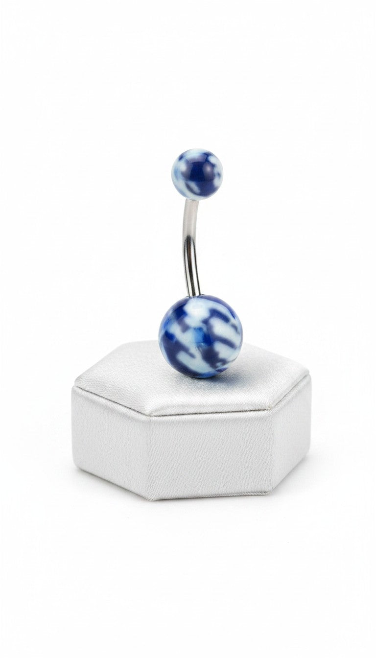 Blue Camouflage Acrylic Belly Button Ring in 316l stainless steel on a silver jewelry display upright angle.