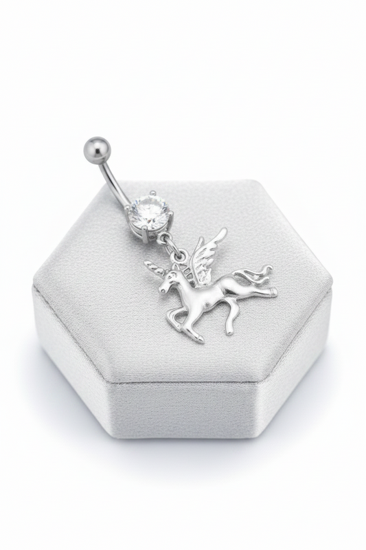 Clear Crystal Pegasus Unicorn Belly Button Ring in 316l stainless steel on a silver silk jewelry display in close up detail.
