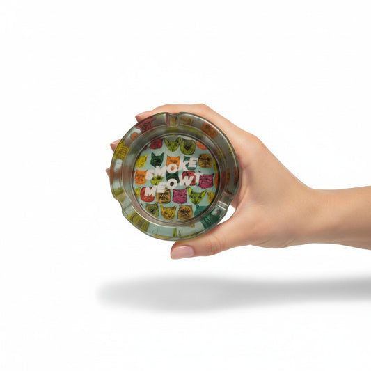 Funny Multi-Cat "Smoke Meowt" 3 Inch Glass Ashtray on a white background being help up in a models hand showing full cat design detail.