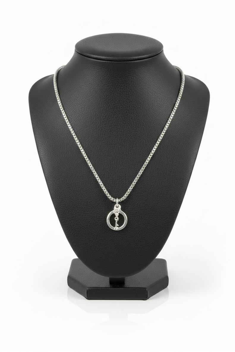 Handcuff with Key Steel Chain Necklace in 316l stainless steel on a black bust with a white background.