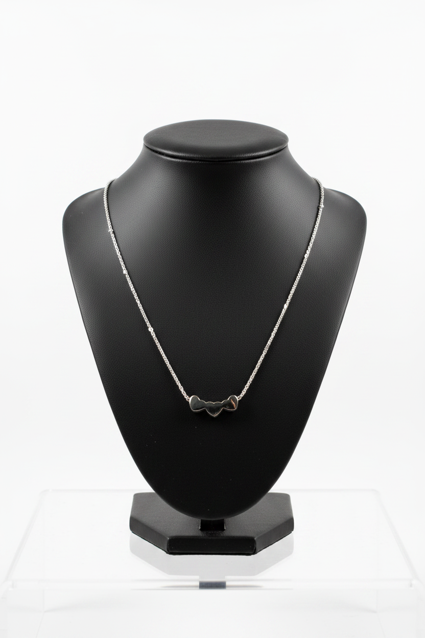 3 Hearts Steel Chain Necklace in 316l stainless steel on a black bust with a white background.