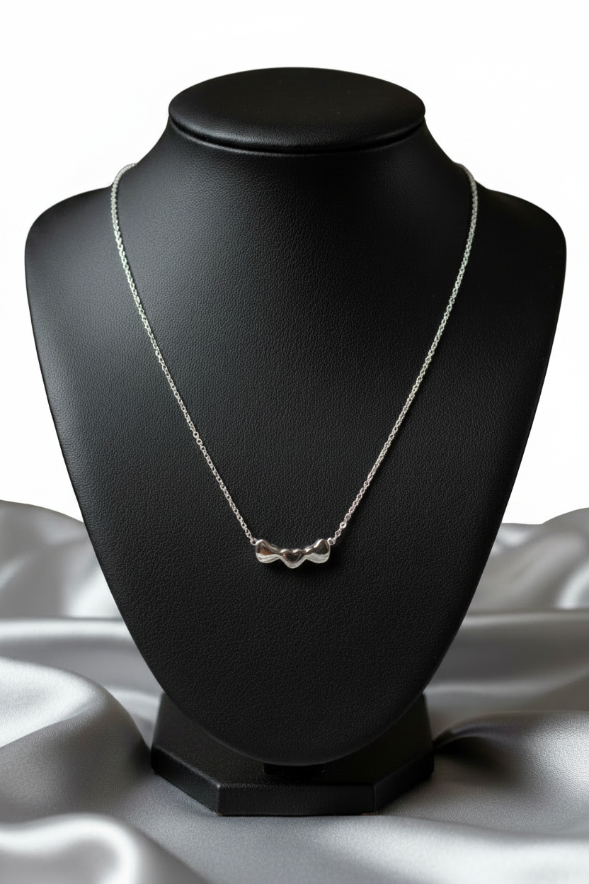 3 Hearts Steel Chain Necklace in 316l stainless steel on a black bust.