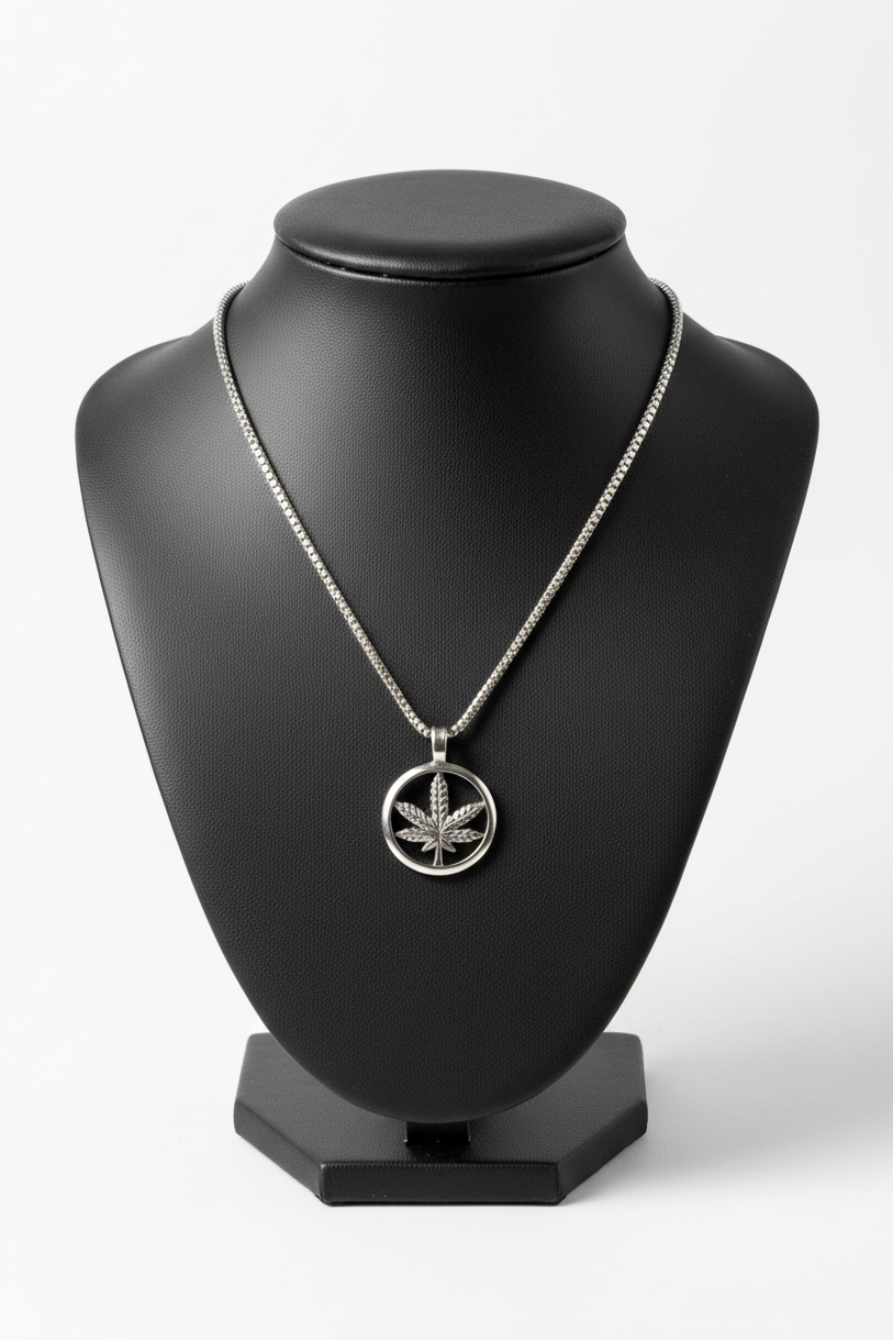Green Leaf Steel Chain Necklace in 316l stainless steel on a black bust with a white background.
