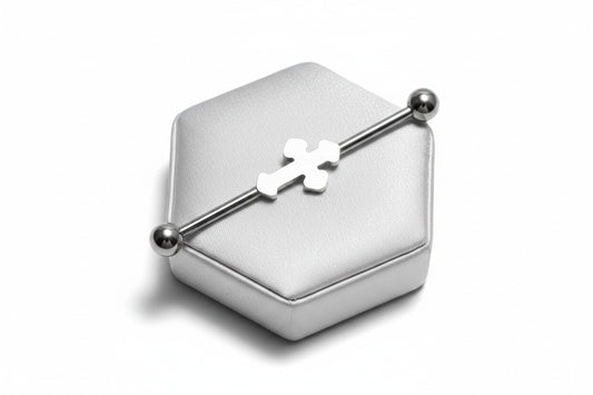 Cross Industrial Ear Barbell in 316l stainless steel on a silver silk jewelry display.