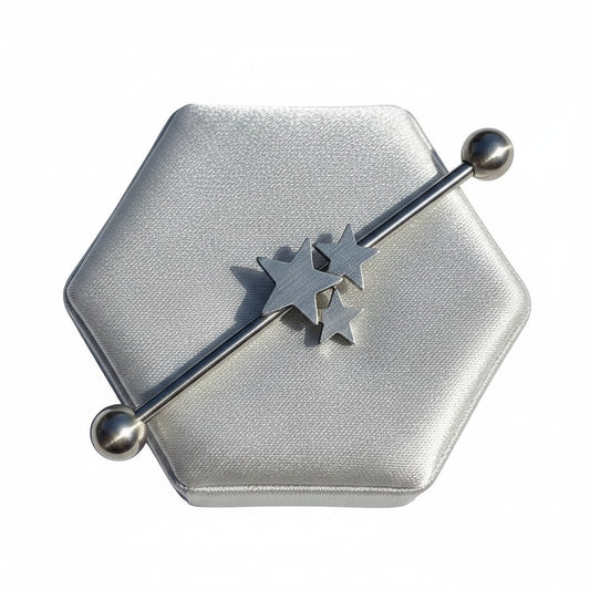 Stars Industrial Ear Barbell in 316l stainless steel on a silver silk jewelry display.