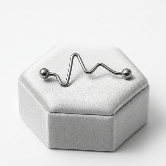 Zigzag Industrial Ear Barbell in 316l stainless steel on a silver silk jewelry display.
