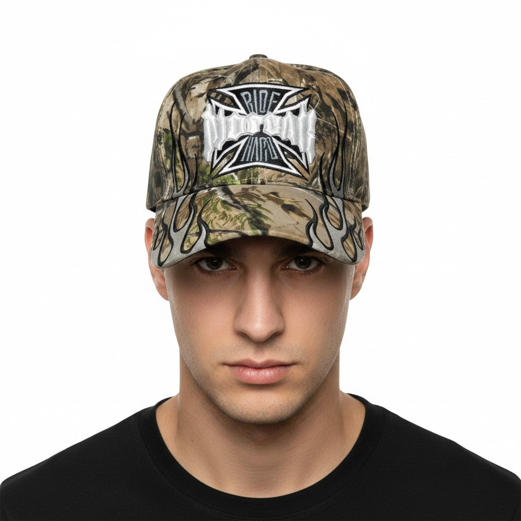 Maltese Cross "No Fear" Adjustable Camouflage Baseball Cap with a white background on a male model front profile.