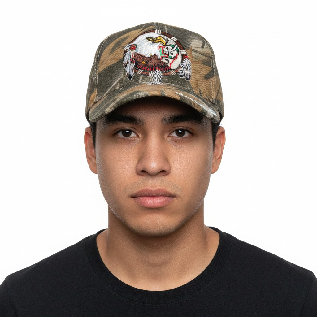 Native Pride Eagle with Dreamcatcher Adjustable Camouflage Baseball Cap with a white background on an Indigenous male model front profile.