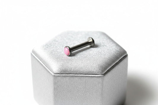 Internally Threaded Light Pink Opal Labret Lip Ring in 316l stainless steel on a silver silk jewelry display.