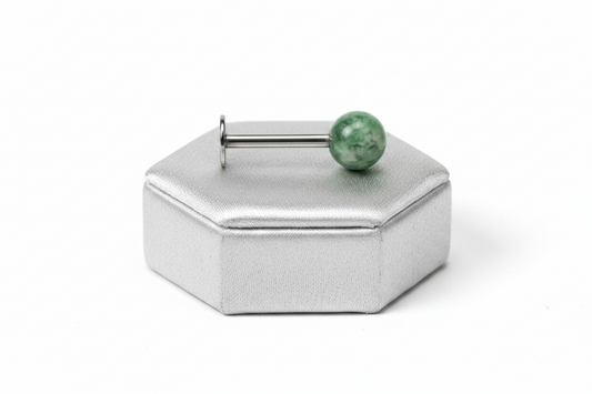 Green Acrylic Labret Lip Ring in 316l stainless steel on a silver silk jewelry display.