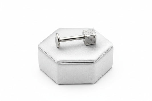 Lucky Steel Dice Labret Lip Ring in 316l stainless steel on a silver silk jewelry display.